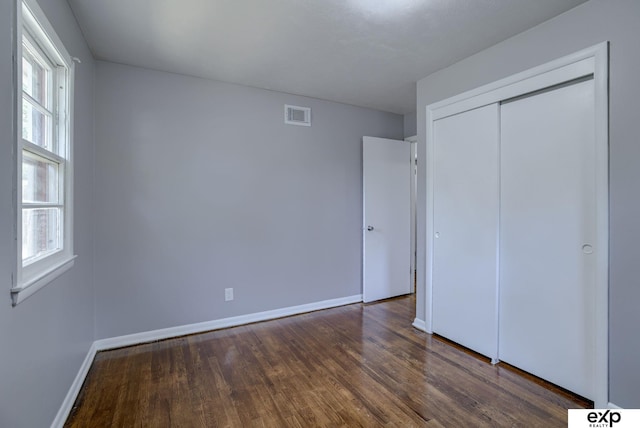7622 Sherman Dr, Omaha, NE 68134 - unfurnished bedroom featuring wood finished floors and a closet