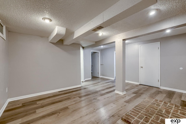 7622 Sherman Dr, Omaha, NE 68134 - finished below grade area featuring a textured ceiling and wood finished floors