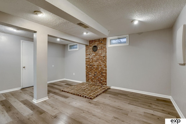 7622 Sherman Dr, Omaha, NE 68134 - finished below grade area featuring a textured ceiling and wood finished floors