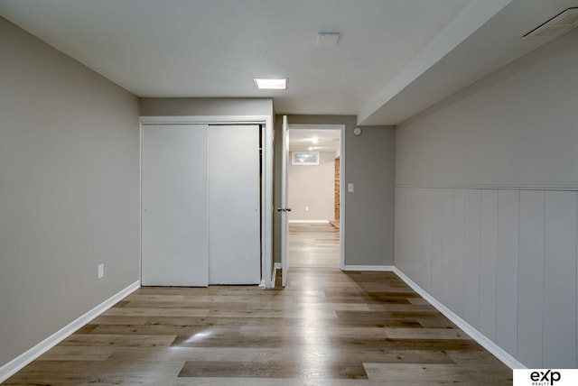 7622 Sherman Dr, Omaha, NE 68134 - unfurnished bedroom featuring wood finished floors, a closet, and a wainscoted wall