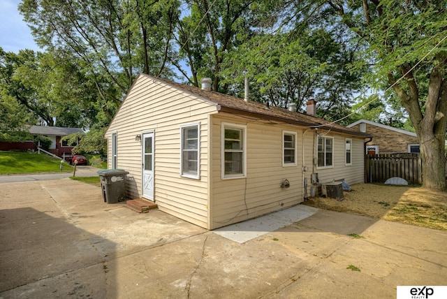 7622 Sherman Dr, Omaha, NE 68134 - view of side of home with a patio, entry steps, and a chimney