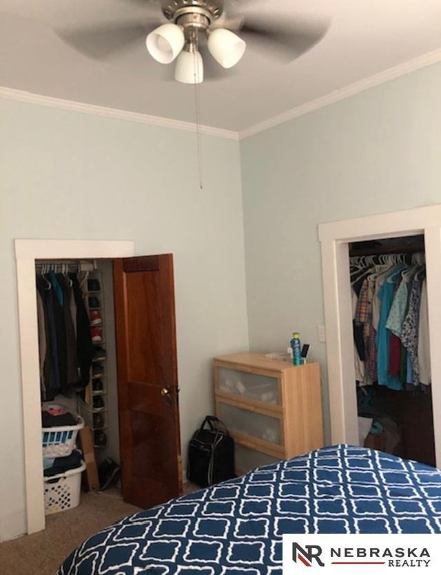 3123 R St, Lincoln, NE 68503 - bedroom featuring a closet, crown molding, carpet floors, and ceiling fan