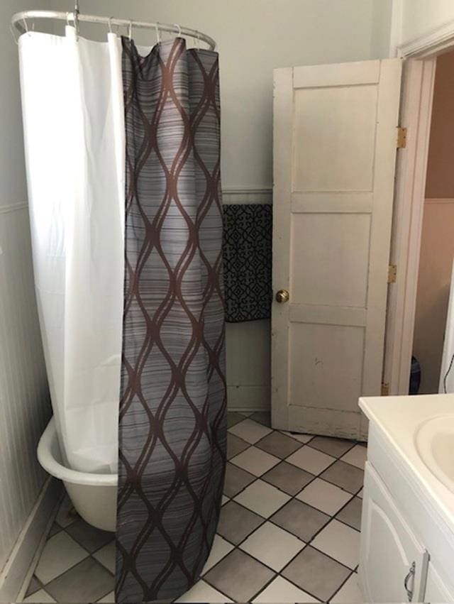 3123 R St, Lincoln, NE 68503 - bathroom featuring vanity, tile patterned flooring, a shower with curtain, and a bath