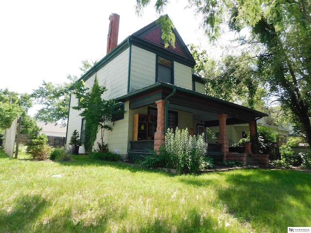 3123 R St, Lincoln, NE 68503 - view of side of home with a porch and a chimney