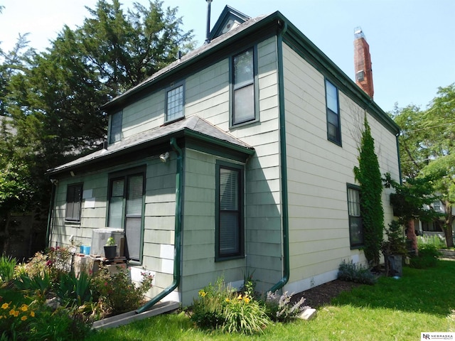 3123 R St, Lincoln, NE 68503 - view of side of home with a chimney and a yard