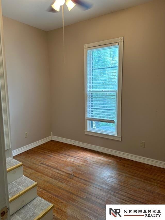 3123 R St, Lincoln, NE 68503 - empty room featuring a ceiling fan and wood finished floors