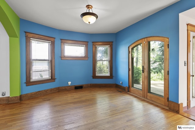 2615 C St, Lincoln, NE 68502 - unfurnished room featuring arched walkways and wood finished floors