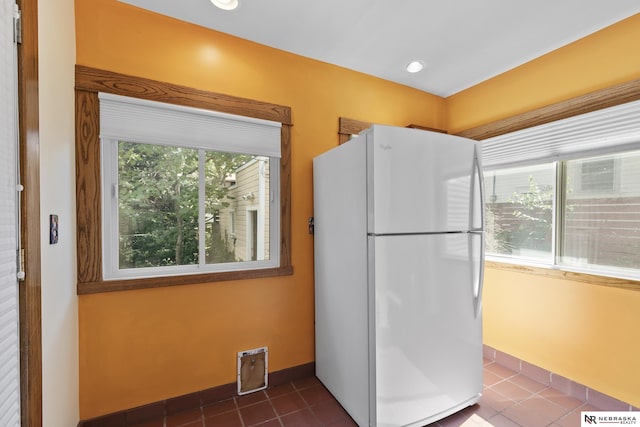 2615 C St, Lincoln, NE 68502 - kitchen featuring freestanding refrigerator and dark tile patterned flooring