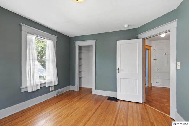 2615 C St, Lincoln, NE 68502 - unfurnished bedroom featuring a closet and light wood-type flooring