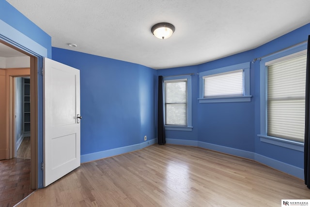 2615 C St, Lincoln, NE 68502 - unfurnished bedroom with wood finished floors and a textured ceiling