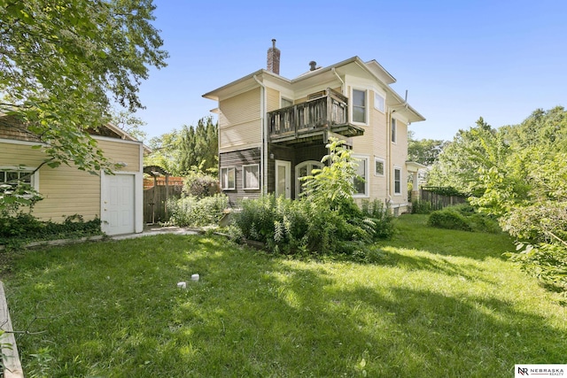 2615 C St, Lincoln, NE 68502 - back of property featuring a balcony, a chimney, and an outdoor structure
