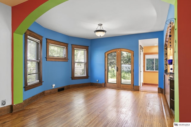 2615 C St, Lincoln, NE 68502 - spare room with wood-type flooring and arched walkways