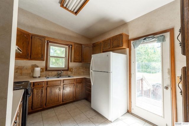 1621 Ridge Rd Lot B, Lot B, Fremont, NE 68025 - kitchen featuring freestanding refrigerator, black range with electric stovetop, plenty of natural light, brown cabinetry, and lofted ceiling