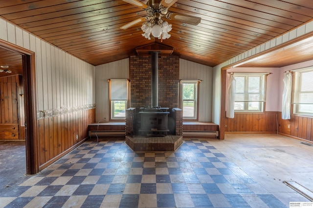1621 Ridge Rd Lot B, Lot B, Fremont, NE 68025 - living room featuring a wood stove, wood walls, a ceiling fan, lofted ceiling, and tile patterned floors