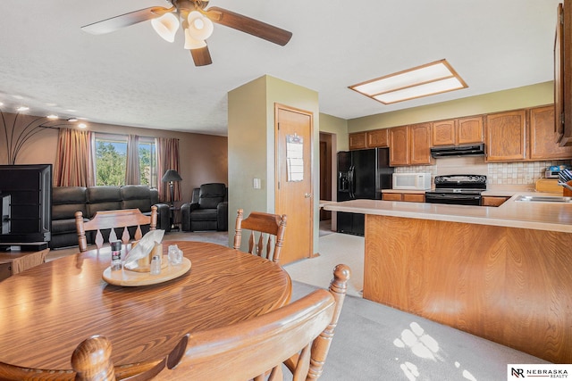 10605 Laurel Ave, Omaha, NE 68134 - dining space with a ceiling fan and light colored carpet