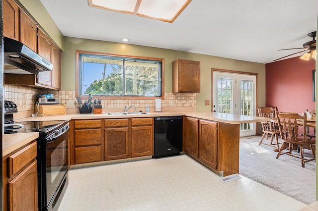 10605 Laurel Ave, Omaha, NE 68134 - kitchen with black appliances, extractor fan, a peninsula, light countertops, and light carpet