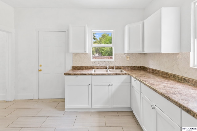 2738 Browne St, Omaha, NE 68111 - kitchen featuring white cabinetry, backsplash, and light tile patterned floors