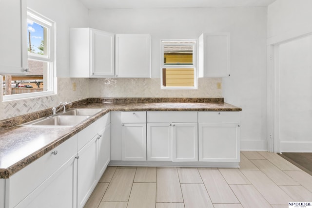 2738 Browne St, Omaha, NE 68111 - kitchen with tasteful backsplash, white cabinets, and dark countertops