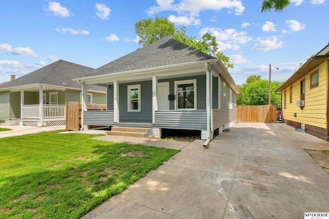 2738 Browne St, Omaha, NE 68111 - view of front of home with a porch, roof with shingles, and driveway