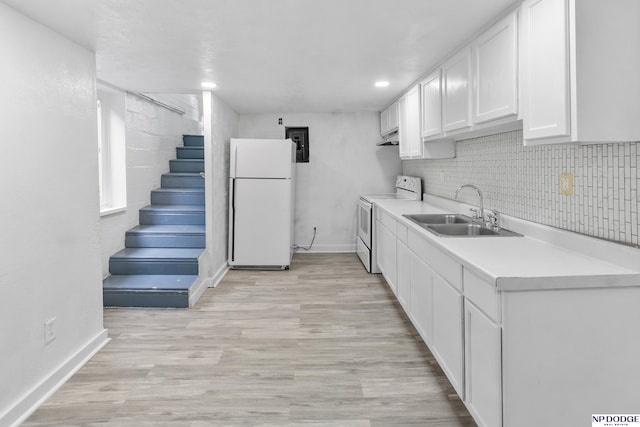 2738 Browne St, Omaha, NE 68111 - kitchen featuring white appliances, white cabinets, light countertops, tasteful backsplash, and light wood-style floors