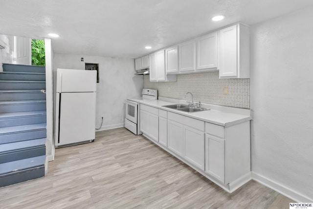 2738 Browne St, Omaha, NE 68111 - kitchen with white appliances, under cabinet range hood, backsplash, light countertops, and white cabinetry