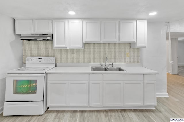 2738 Browne St, Omaha, NE 68111 - kitchen with electric range, ventilation hood, white cabinets, light countertops, and recessed lighting