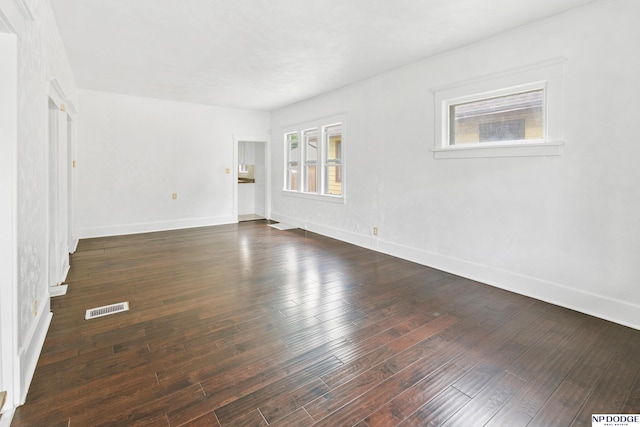 2738 Browne St, Omaha, NE 68111 - unfurnished living room with baseboards and dark wood finished floors