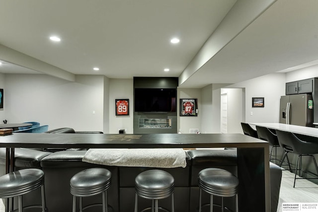 20709 Woodridge Dr, Gretna, NE 68028 - bar area featuring stainless steel refrigerator with ice dispenser, recessed lighting, and light wood finished floors