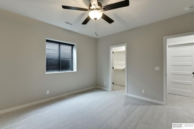 20709 Woodridge Dr, Gretna, NE 68028 - unfurnished bedroom featuring light carpet, a walk in closet, ceiling fan, and a closet