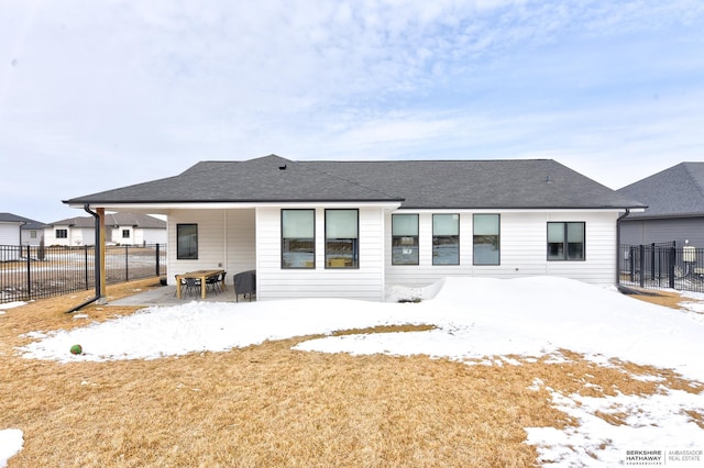 20709 Woodridge Dr, Gretna, NE 68028 - snow covered back of property with a patio area and a shingled roof