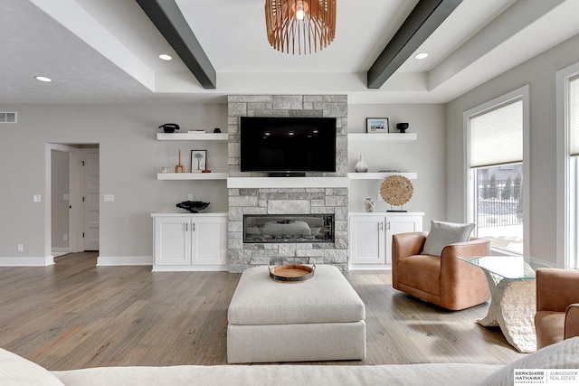 20709 Woodridge Dr, Gretna, NE 68028 - living room with light wood finished floors, a stone fireplace, and beamed ceiling