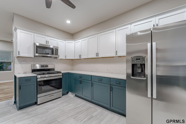 2551 Meredith Ave, Omaha, NE 68111 - kitchen featuring appliances with stainless steel finishes, white cabinets, light countertops, ceiling fan, and decorative backsplash