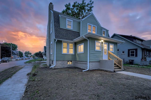 2551 Meredith Ave, Omaha, NE 68111 - view of front facade featuring a chimney and roof with shingles