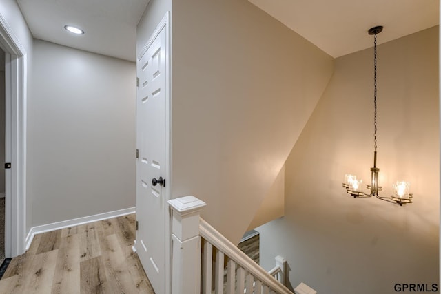 2551 Meredith Ave, Omaha, NE 68111 - hall with an upstairs landing, light wood-style flooring, a chandelier, and recessed lighting
