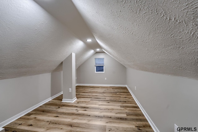 2551 Meredith Ave, Omaha, NE 68111 - bonus room featuring a textured ceiling, wood finished floors, and vaulted ceiling