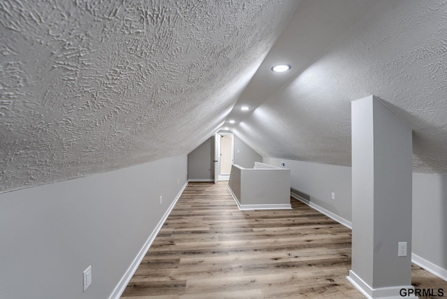2551 Meredith Ave, Omaha, NE 68111 - bonus room featuring a textured ceiling, wood finished floors, vaulted ceiling, and recessed lighting