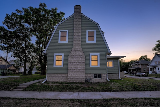 2551 Meredith Ave, Omaha, NE 68111 - view of home's exterior featuring a chimney and a gambrel roof