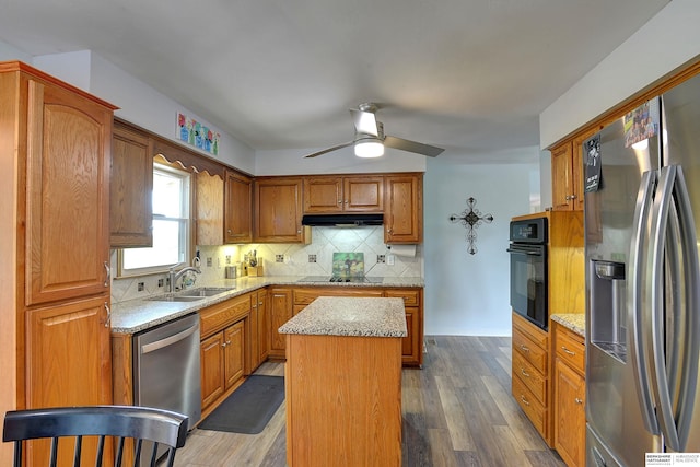 4625 S 222nd St, Elkhorn, NE 68022 - kitchen with black appliances, backsplash, under cabinet range hood, a center island, and a ceiling fan