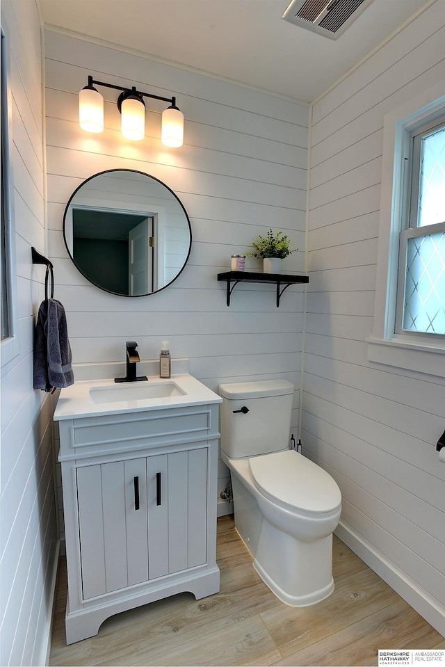 4625 S 222nd St, Elkhorn, NE 68022 - half bathroom with vanity, wood finished floors, and wooden walls