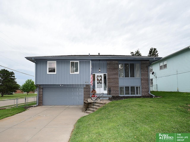 9705 Cady Ave, Omaha, NE 68134 - split foyer home with brick siding, a garage, driveway, and board and batten siding