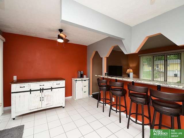 9705 Cady Ave, Omaha, NE 68134 - indoor bar featuring ceiling fan and light tile patterned floors