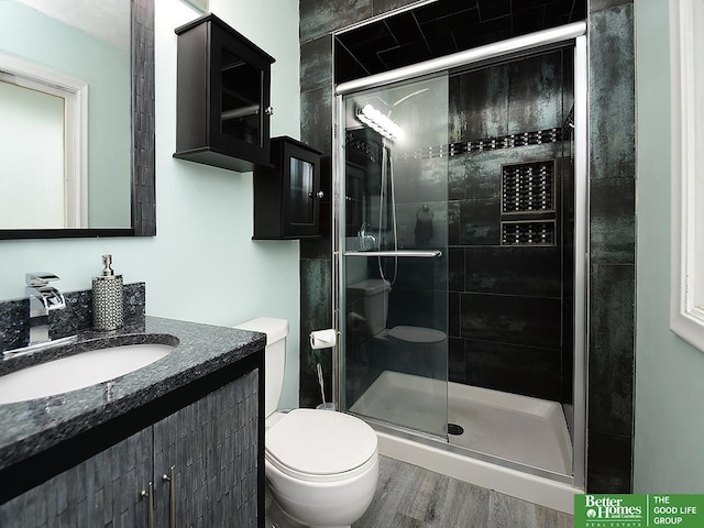 9705 Cady Ave, Omaha, NE 68134 - bathroom featuring a shower stall, vanity, and wood finished floors