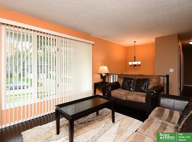 9705 Cady Ave, Omaha, NE 68134 - living area featuring wood finished floors, a chandelier, and a textured ceiling