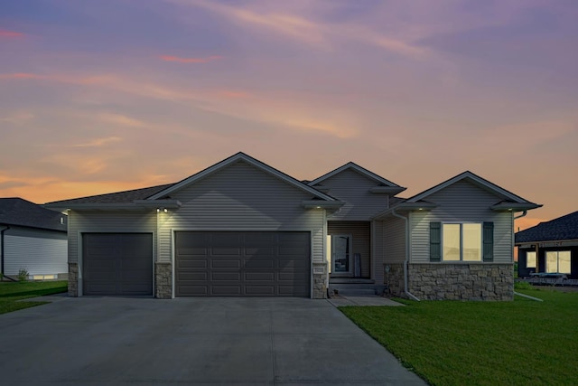 7420 Isidore Dr, Lincoln, NE 68516 - view of front of home featuring stone siding, a garage, driveway, and a front lawn