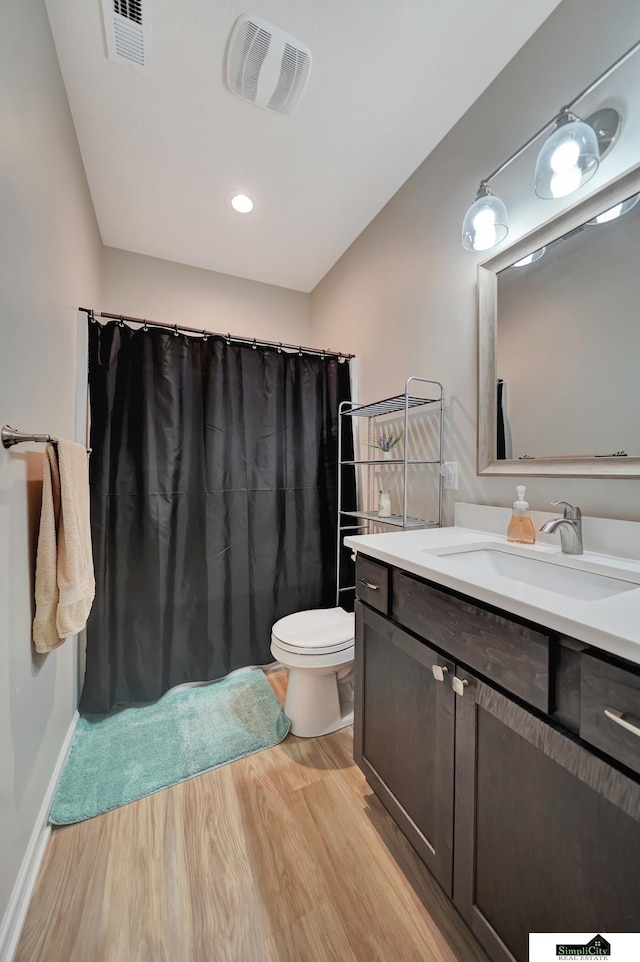 7420 Isidore Dr, Lincoln, NE 68516 - full bathroom featuring wood finished floors, vanity, and curtained shower