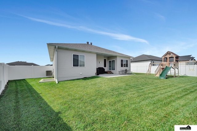 7420 Isidore Dr, Lincoln, NE 68516 - back of property with a fenced backyard, a patio, and a playground