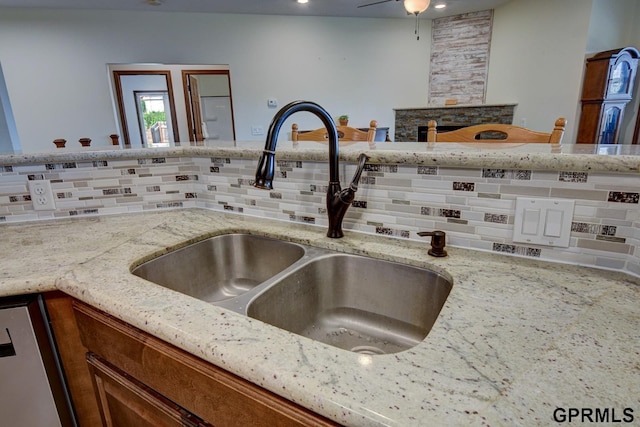 3320 Fairway Dr, Plattsmouth, NE 68048 - kitchen view of decorative backsplash, dishwasher, and light stone counters