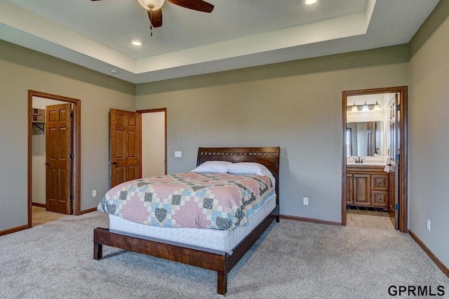 3320 Fairway Dr, Plattsmouth, NE 68048 - carpeted bedroom with a tray ceiling, recessed lighting, connected bathroom, a ceiling fan, and a walk in closet