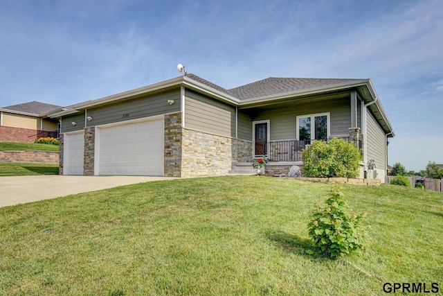 3320 Fairway Dr, Plattsmouth, NE 68048 - view of front of house featuring a garage, a porch, driveway, a front lawn, and stone siding