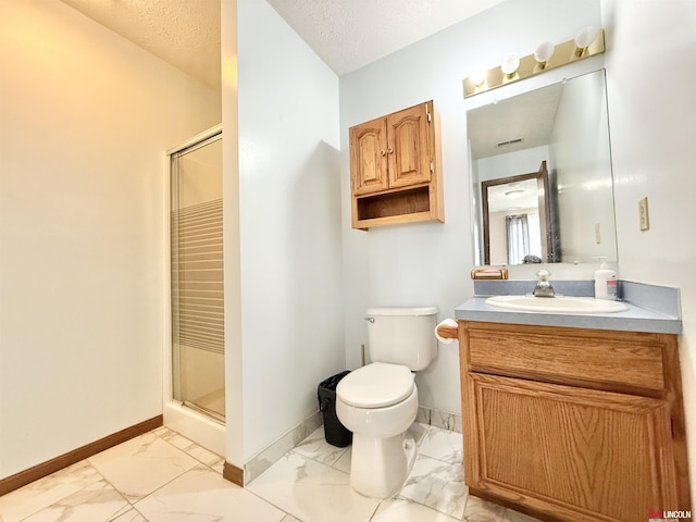 724 W Belmont Ave, Lincoln, NE 68521 - bathroom featuring marble finish flooring, a stall shower, vanity, and a textured ceiling